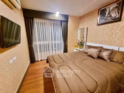 Cozy bedroom with elegant decor and wall-mounted TV in modern apartment