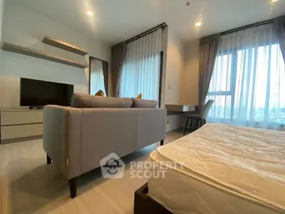 Modern studio apartment with stylish decor and large windows offering city views.