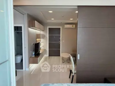 Modern apartment interior with sleek design and open layout, featuring a cozy living area and stylish furnishings.