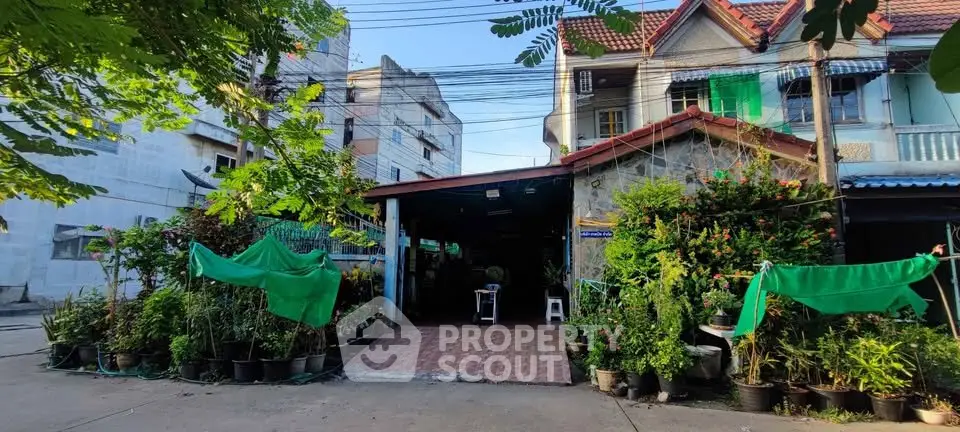 Charming residential property with lush greenery and spacious entrance in a serene neighborhood.