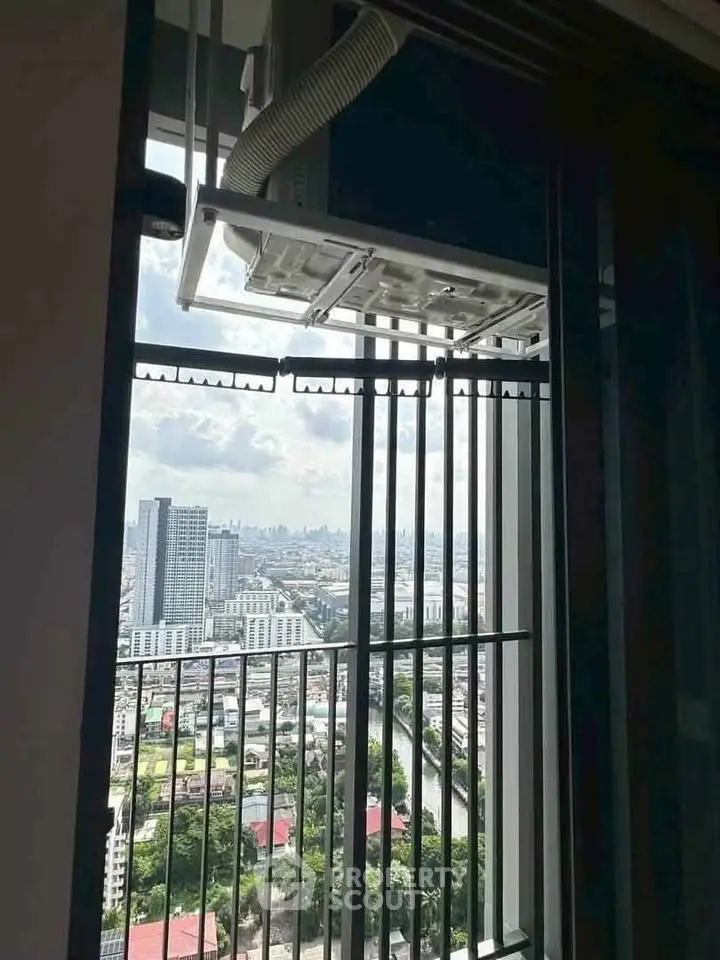 Stunning high-rise balcony view overlooking cityscape with modern architecture and lush greenery.