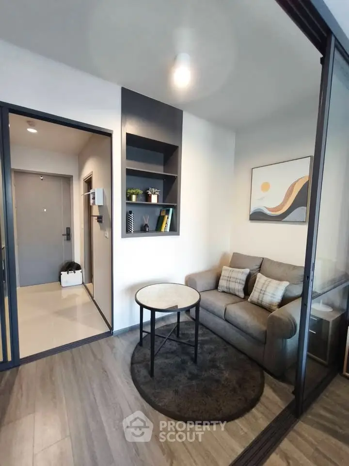 Modern living room with cozy sofa and stylish decor in a contemporary apartment.