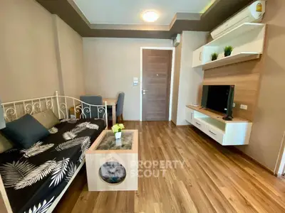 Chic living room with modern decor and wooden flooring in a cozy apartment.