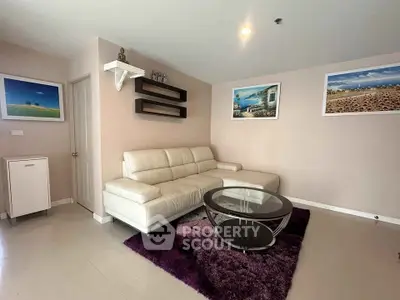 Modern living room with white leather sofa and glass coffee table