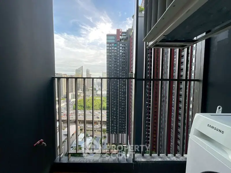 Stunning urban view from a high-rise balcony with city skyline and modern architecture.