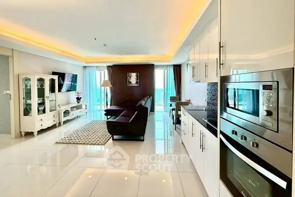 Modern open-plan living room with sleek kitchen and stylish decor