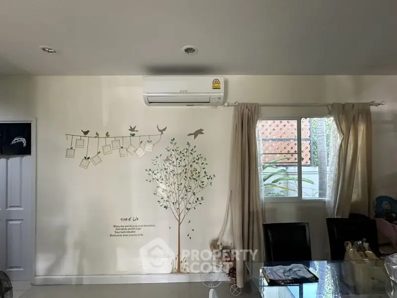 Charming dining area with wall art and natural light, perfect for cozy meals.