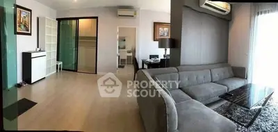 Spacious modern living room with gray sectional sofa and stylish decor