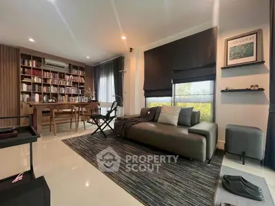 Modern living room with stylish decor and large bookshelf, perfect for relaxation and entertainment.