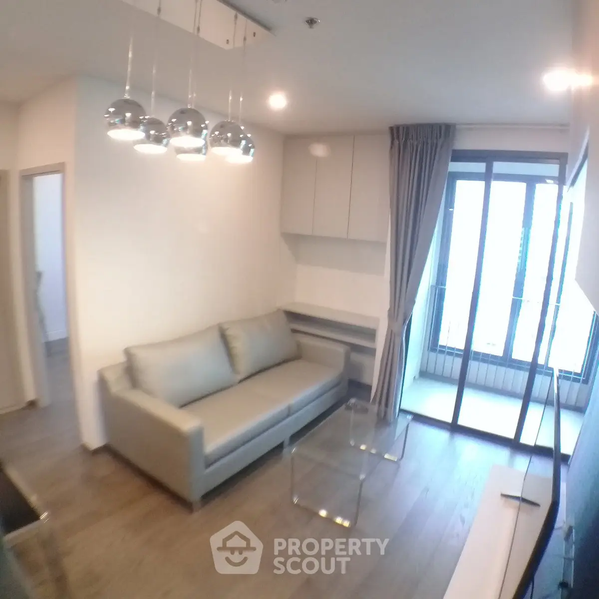 Modern living room with sleek design and large windows offering natural light.