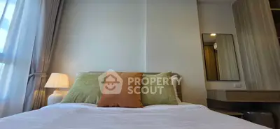Cozy bedroom with stylish decor and natural light, featuring a comfortable bed and elegant furnishings.