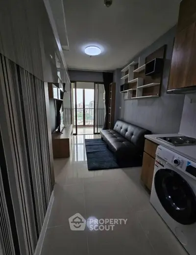 Modern apartment living room with sleek furniture and city view balcony