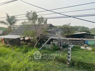 Rural property with rustic structures and lush greenery, ideal for agricultural or development opportunities.