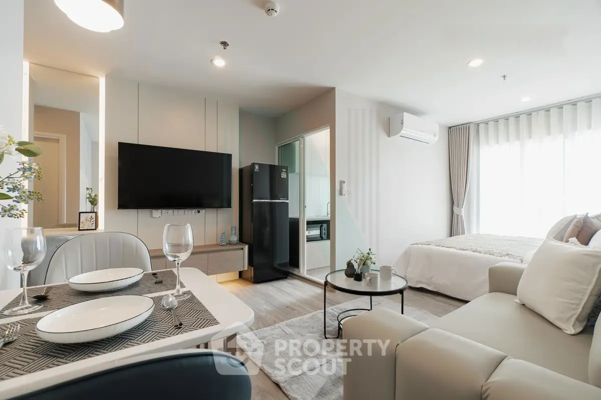 Modern studio apartment with open layout, featuring a cozy living area, dining space, and stylish bedroom.