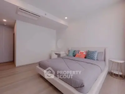 Spacious modern bedroom with stylish decor and cozy ambiance