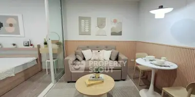 Chic modern living room with cozy sofa and stylish decor in a compact apartment setting.