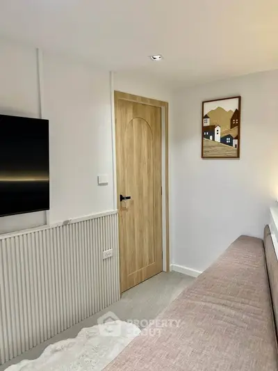Modern living room with stylish decor and wall-mounted TV