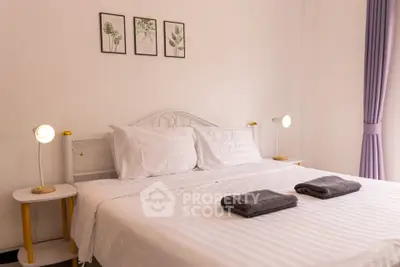 Cozy bedroom with elegant decor and soft lighting, perfect for relaxation.