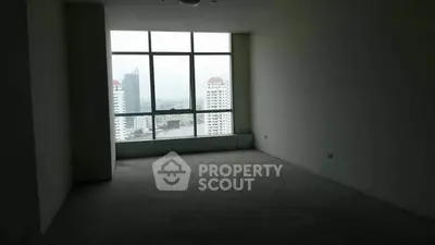 Spacious empty room with large window offering city view