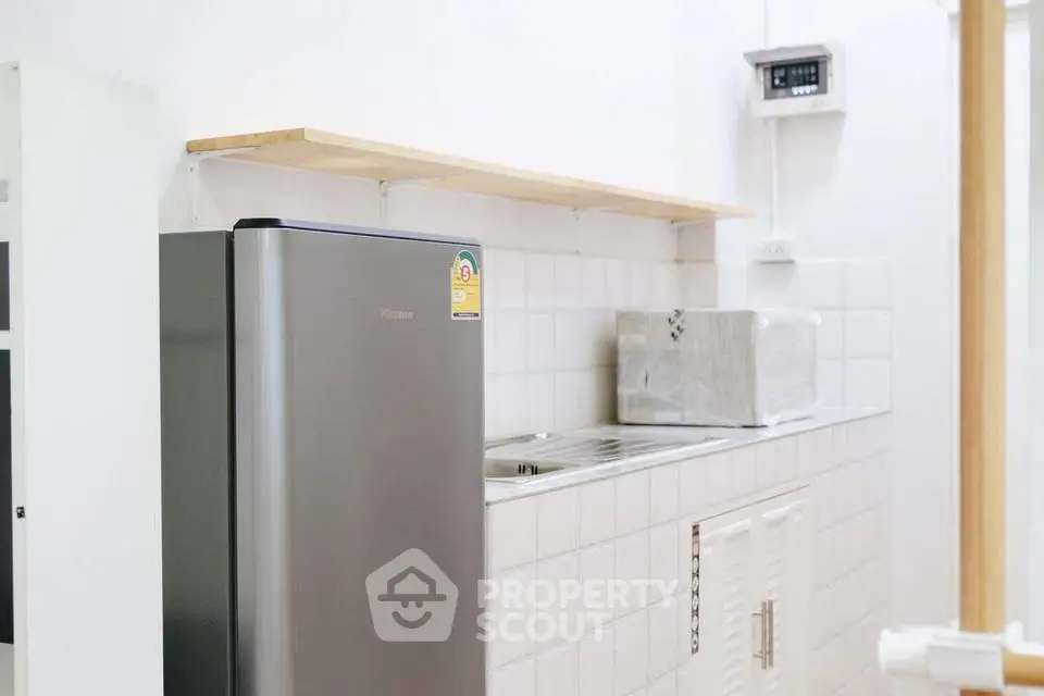 Modern kitchen with sleek fridge and minimalist design