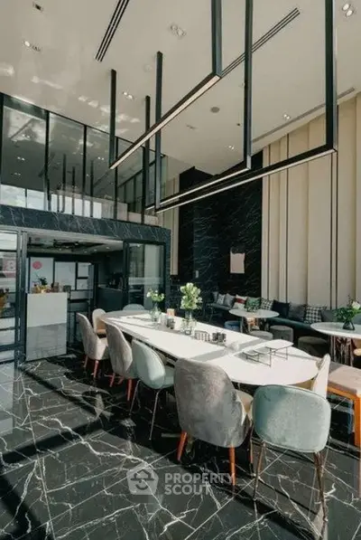 Luxurious modern dining area with high ceilings and elegant marble flooring in a stylish apartment complex.