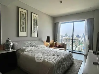 Luxurious bedroom with stunning city view and elegant decor in high-rise apartment.