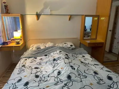 Cozy bedroom with unique Snoopy-themed bedding and built-in wooden shelves.