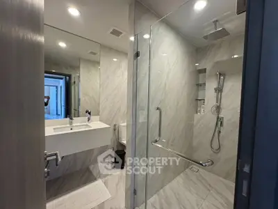 Modern bathroom with glass shower and sleek fixtures