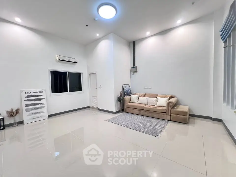 Spacious modern living room with sleek design and cozy seating area.