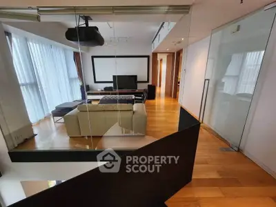 Spacious modern living room with sleek design and large windows for natural light.