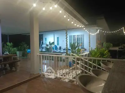 Charming outdoor patio with string lights and lush greenery at night