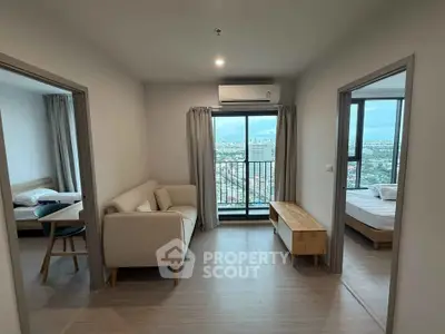 Modern apartment interior with two bedrooms and city view balcony.