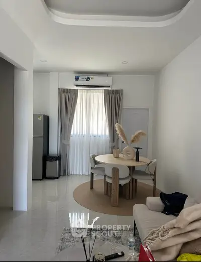 Modern living room with elegant dining area and natural light