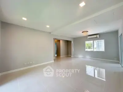 Spacious modern living room with glossy tile flooring and elegant lighting