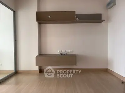 Modern minimalist interior with sleek shelving and light wood flooring, perfect for stylish living.