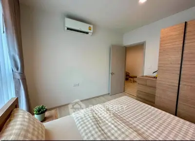 Cozy bedroom with modern air conditioning and stylish wooden furniture, perfect for comfort and relaxation.