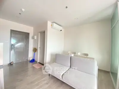 Modern living room with minimalist decor and sleek furniture in a bright apartment.
