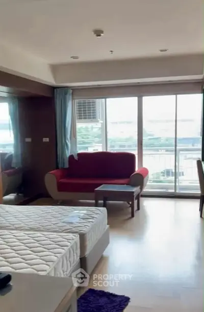 Spacious bedroom with balcony view and modern furnishings