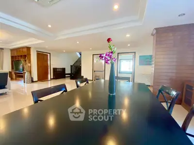Spacious open-plan living area with elegant dining table and modern decor
