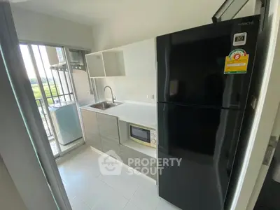 Modern kitchen with sleek appliances and balcony view