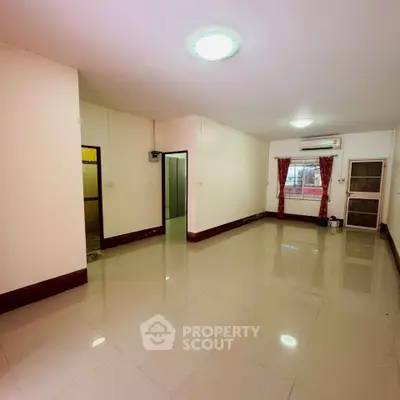 Spacious living room with tiled flooring and air conditioning, ideal for modern living.