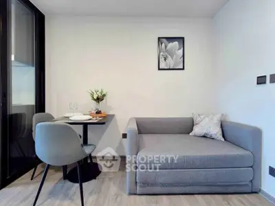 Modern living room with cozy gray sofa and dining area, perfect for urban living.