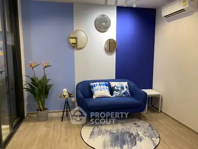 Modern living room with blue accent wall and stylish decor