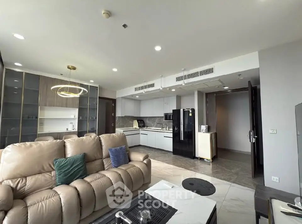 Spacious modern living room with open kitchen and elegant furnishings