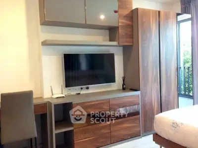 Modern bedroom with sleek wooden furniture and wall-mounted TV