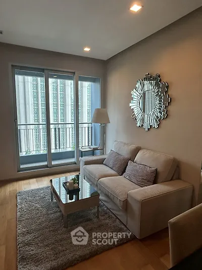 Stylish living room with modern decor and large windows for natural light.