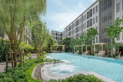 Luxurious apartment complex with stunning pool and lush greenery, perfect for relaxation and modern living.