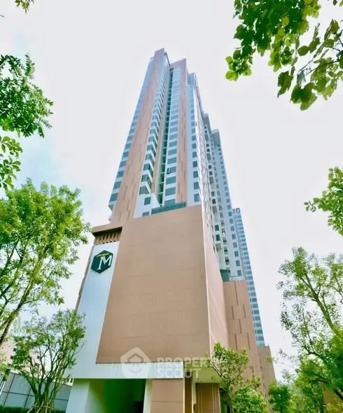 Stunning high-rise building with modern architecture and lush greenery, perfect for urban living.
