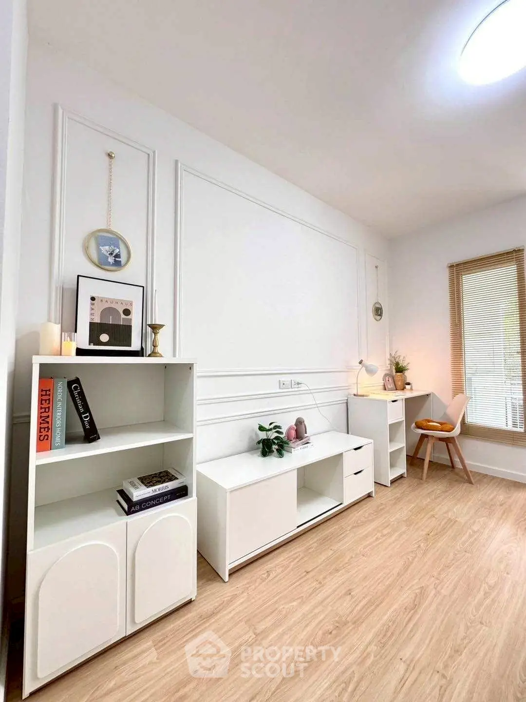 Stylish study room with modern white furniture and wooden flooring