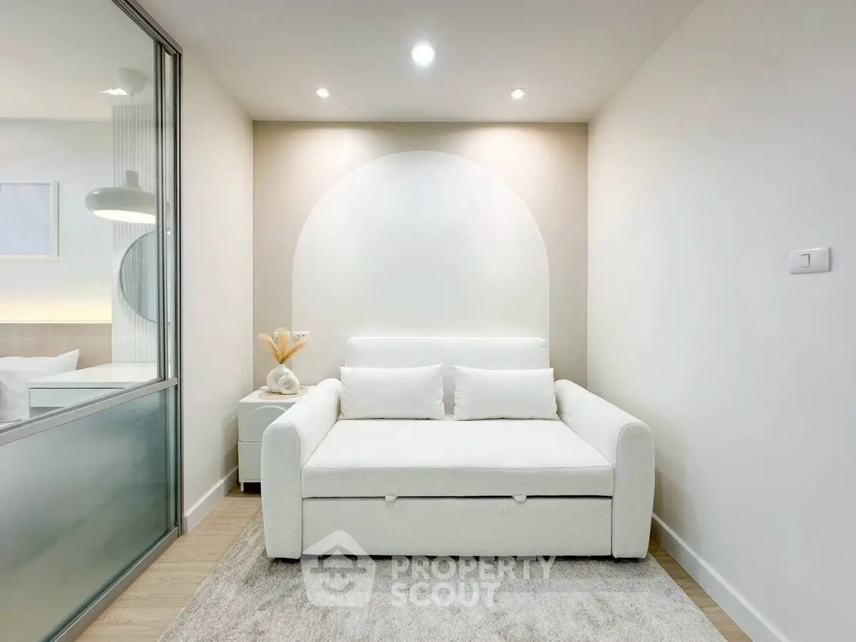 Modern minimalist living room with white sofa and soft lighting